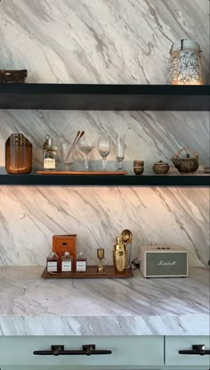 the shelves in this kitchen are filled with bottles and glasses