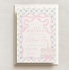 a pink birthday card with a cake and ribbon on the front that says 1st birthday