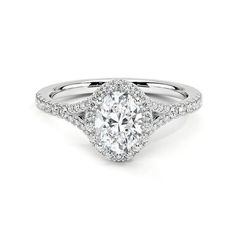 a white gold engagement ring with an oval center stone and pave set diamonds around the band