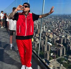 a man standing on top of a tall building