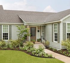 a gray house with white trim and windows