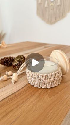 a video demonstrating how to crochet a candle holder with yarn and wood beads