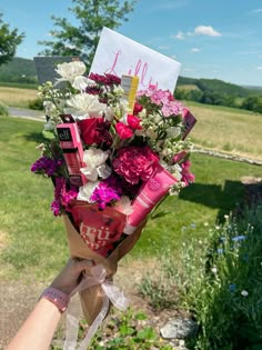 a person holding a bouquet of flowers in their hand