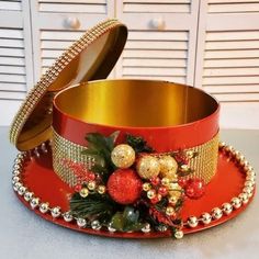 a red hat with gold trim and ornaments on it sitting on a white counter top