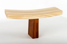 a wooden bench sitting on top of a white floor