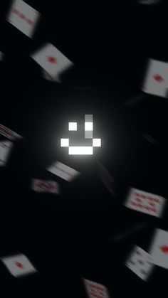 an image of a smiley face in the middle of many cards flying around it's head