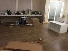 an empty room with boxes on the floor