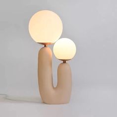 two lamps sitting next to each other on top of a table