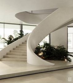 a white staircase with plants in the middle