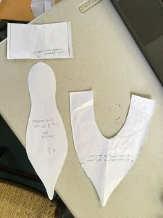 two pieces of paper are cut out to look like the shape of a woman's torso