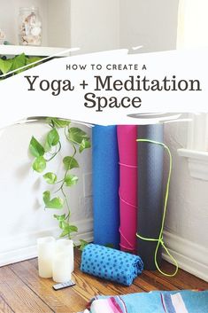 yoga mats and candles on the floor in front of a potted houseplant