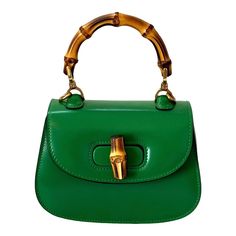 -Gucci Dyana Lux Calfskin Mini Bamboo 1947 Top Handle Bag  -Green calfskin leather -Bamboo handle -Two removable shoulder straps -Turnlock closure -Interior pocket   Authenticity: -Stamped Gucci on hardware and interior pocket   Dimensions: 6.75” L x 4.5” H x 3” D Classic Evening Shoulder Bag With Bamboo Handle, Gucci Top Handle Evening Satchel, Vintage Gucci Top Handle Shoulder Bag, Gucci Handheld Shoulder Bag With Detachable Handle, Luxury Satchel Shoulder Bag With Bamboo Handle, Gucci Satchel With Bamboo Handle, Gucci Top Handle Shoulder Bag With Bamboo Handle, Green Gucci Bag With Detachable Handle, Gucci Bamboo Handle Rectangular Bag