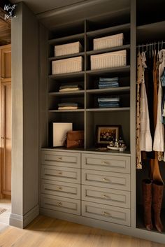 Walk in closet in primary bedroom with open shelving. Blue-grey paint on the walls and hardwood floors. Gold hardware on drawers and sliding door. English Country Walk In Closet, Sage Green Walk In Closet, Traditional Walk In Closet, Walk In Closet Aesthetic, Walk In Closet Inspiration, West Of Main, Primary Closet, Master Bath And Closet, Closet Colors