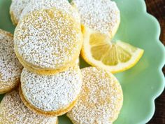 powdered sugar covered lemon cookies on a green plate