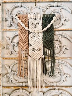 three macrame wall hangings with tassels and beads