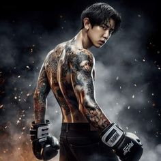 a man with tattoos and boxing gloves on