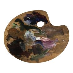 a wooden palette with lots of paint on it