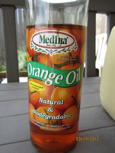 a bottle of orange oil sitting on top of a table