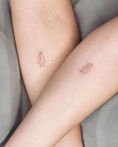 a person laying in bed with their legs crossed and tattooing on the side of her leg