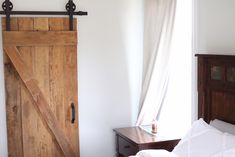 a bed room with a wooden headboard and a sliding door