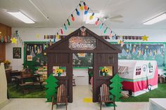 a room filled with lots of toys and decorations on the walls, including a welcome sign