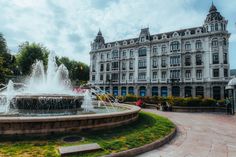 a fountain in front of a large building