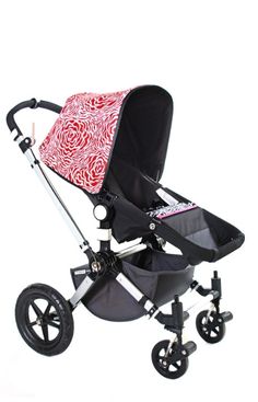 a stroller with a red and white design on it