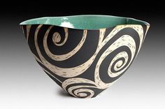 a black and white bowl with swirl designs on it