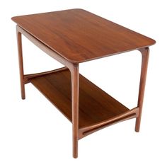 a small wooden table with two shelves on the bottom and one shelf below it, against a white background