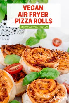 vegan air fryer pizza rolls with basil leaves on top and tomatoes in the background