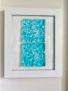 a white frame with blue water in it