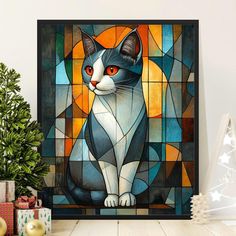 a black and white cat sitting in front of a stained glass window