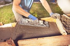 a man is working with cement in the yard