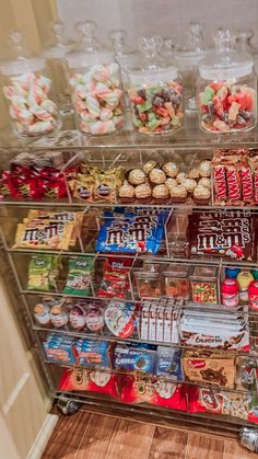 a display case filled with lots of different types of candy and candies in plastic containers