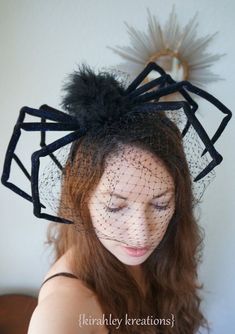 a woman wearing a black veiled headpiece with feathers on it's side