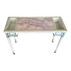 a white and pink marble top coffee table with two legs on each side, in the shape of a rectangle