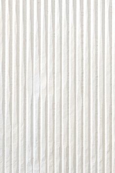 a white wall with vertical lines painted on it