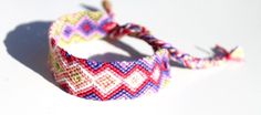 *BRACELET DETAILS  Beautiful handwoven friendship bracelet with a tie dye pattern and the colors of Dark Pink, Pink, Purple, Light Purple, Light Green, Coral and White.  The woven part of this bracelet is 2 centimeters wide and 14 centimeters long. There are braided ties on both ends. This bracelet is made out of 100% premium cotton which not only means the colors are long lasting but also it lightweight to wear.  Packaging holder is made from recycled cardboard material.  *SHIPPING FREE US shipping! International shipping available too! This bracelet will ship 1-4 business days from Rochester, Michigan USA. *ADD STACKABLE BRACELETS Add some thin and simple stacking bracelets to your order. Simple bracelets are great for stacking/layering with other bracelets.  Add them to your order by fo Adjustable Hippie Style Bracelets As Gift, Hippie Style Adjustable Bracelets As Gifts, Multicolor Jubilee Bracelet For Festivals, White Hippie Bracelet Jewelry, Pink Jewelry For Gift, Colorful Adjustable Bracelets For Friendship, Colorful Unique Beaded Bracelets For Gifts, Colorful Bracelet Jewelry As Gift, Colorful Bracelet Jewelry Gift