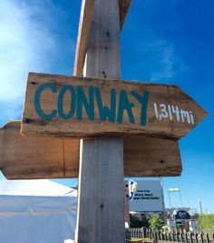 a wooden sign that says conway on it