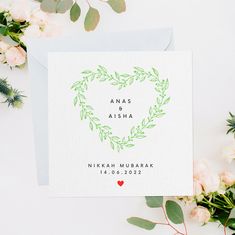 a card with the words anas aisha written on it next to flowers and greenery