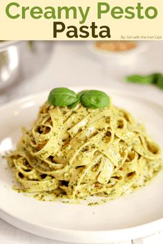 creamy pesto pasta on a white plate with basil garnish and text overlay