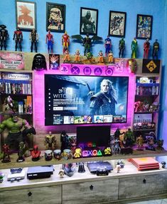 a tv sitting on top of a dresser next to a shelf filled with action figures