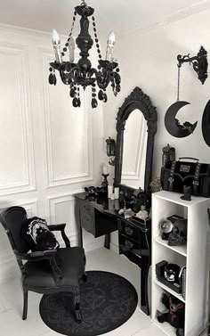 a black and white photo of a living room with chandelier, chair, mirror and other items