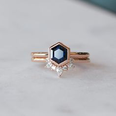 a diamond and blue sapphire engagement ring set in yellow gold with diamonds on each side