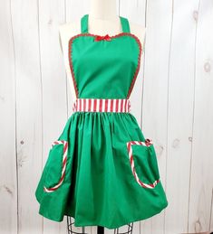 a green apron on a mannequin with red and white striped trimmings