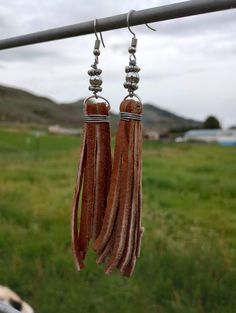 Handmade tassel earrings Handmade Artisan Tassel Earrings, Adjustable Fringe Tassel Dangle Earrings, Southwestern Tassel Earrings For Festivals, Turquoise Handmade Tassel Earrings For Festivals, Brown Dangle Tassel Earrings With Fringe, Brown Fringe Dangle Tassel Earrings, Brown Dangle Earrings With Tassels, Southwestern Tassel Earrings, Elegant Handmade Turquoise Tassel Earrings