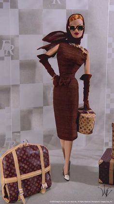 a woman in a brown dress is standing next to luggage