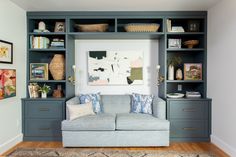 a living room filled with furniture and lots of shelves