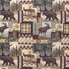 an animal themed quilt with moose and elk on it's squares in the woods