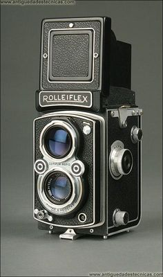 an old fashioned camera is shown on a gray background with the words rolleiflex above it